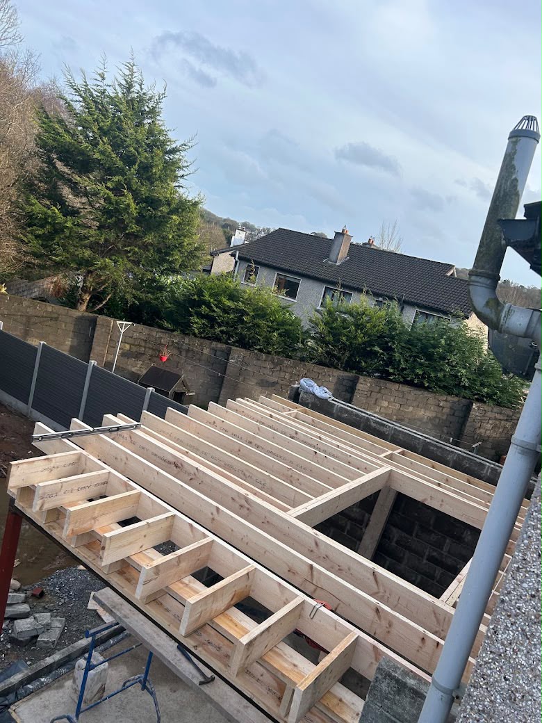New timber floor joists set out over blockwork during construction